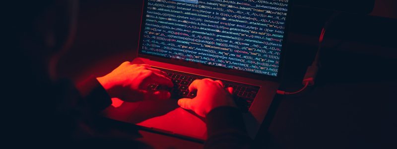 Man using computer and programming  to break code. Cyber security threat. Internet and network security. Stealing private information. Person using technology to steal password and private data. Cyber attack crime